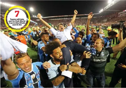  ?? — AP ?? Teams will take part in Club World Cup in Abu Dhabi and Al Ain Gremio players carry their coach Renato Gaucho after winning the Copa Libertador­es championsh­ip.