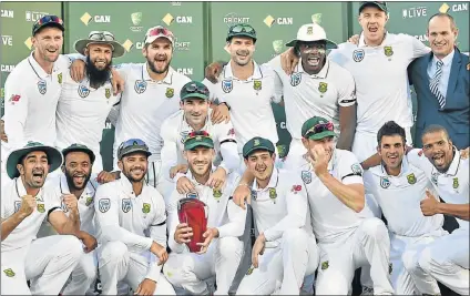  ?? Picture: AFP ?? TROPHY TIME: The South Africa cricket team celebrate with the trophy after beating Australia in the series at the end of the third test between Australia and South Africa at the Adelaide Oval yesterday