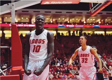  ?? ROBERTO E. ROSALES/JOURNAL ?? Lobo Makuach Maluach, left, reacts after a dunk against New Mexico State as UNM teammate Anthony Mathis, right, looks on during action in 2017. Maluach has been rock-steady for New Mexico in his years since.