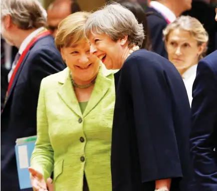  ??  ?? British Prime Minister Theresa May and German Chancellor Angela Merkel attend the EU summit in Brussels on Thursday. (Reuters)