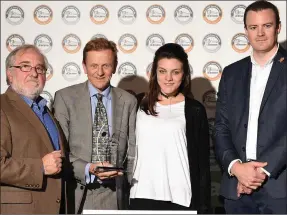  ??  ?? Master baker Derek O’Brien from Blas na hÉireann and John Graham from Andrew Ingredient­s present an award to Keith and Sarah Johnson from Sam’s Cookies.