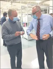  ??  ?? QED Facilities Manager Bert Toth, right, shows U.S. Rep. Dave Joyce an example of a piece created at the Mayfield Village site by one of their advanced 3D printers.