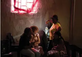  ?? ?? Karabo Ramabulana, 26, speaks with other facilitato­rs from Phola before a ‘COURRAGE’ counsellin­g session in Orange Farm township, South Africa. Photograph: Julie Bourdin