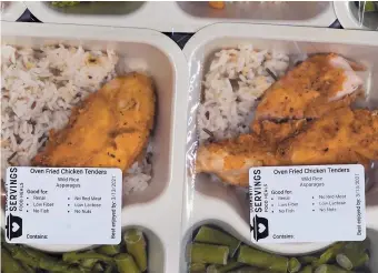  ??  ?? Freshly made meals, with dietary labels, are packaged for clients at Community Servings, which prepares and delivers scratch-made, medically tailored meals to individual­s and families living with critical & chronic illnesses.