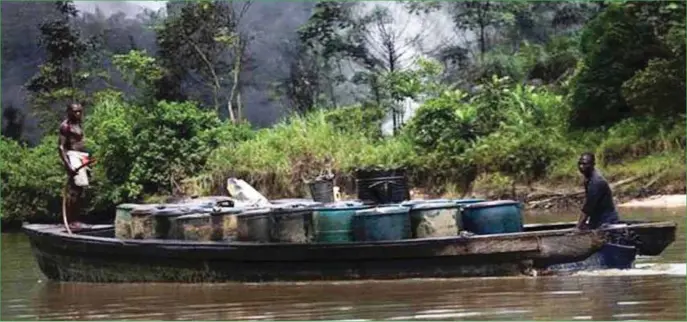  ??  ?? Oil thieves in the creeks making a way with drums of stolen crude