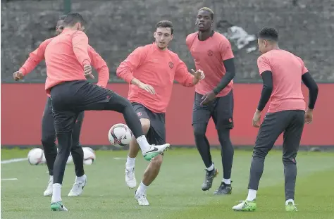  ?? — AFP ?? Manchester United’s Matteo Darmian (second left) and Paul Pogba (second right) attend a team training session at the club’s training complex near Carrington, west of Manchester in north west England, ahead of their UEFA Europa League final.