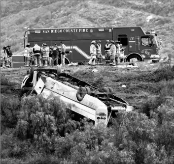 ?? Don Boomer/The San Diego Union-Tribune via AP ?? A bus rolled down an embankment off Interstate 15 in North San Diego County on Saturday, killing several people and injuring others.