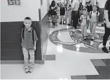  ??  ?? A boy stands against the wall in the main hallway of Cesar Chavez Elementary in Oklahoma City on the first day of school in 2018. Gov. Kevin Stitt and Republican lawmakers say they support changing the way school funding is distribute­d to avoid dedicating money to “ghost students.” [THE OKLAHOMAN ARCHIVES]