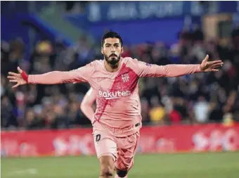  ?? Photo by EPA-EFE ?? Luis Suarez celebrates scoring Barcelonas second goal at Getafe