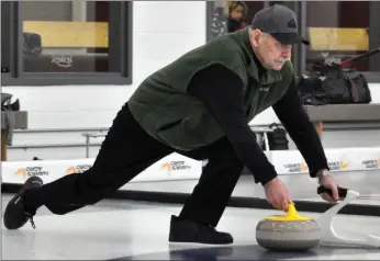  ??  ?? League coordinato­r Don Reimer, who also skips a team, releases a stone during a Monday afternoon game, March 4.