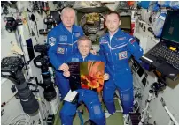  ??  ?? Russian cosmonauts displaying Dr Hersh Chadha’s photo in Internatio­nal Space Station and (right) Chadha with the cosmonauts.