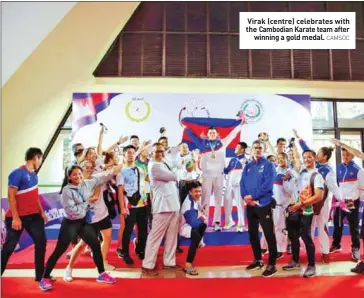  ?? CAMSOC ?? Virak (centre) celebrates with the Cambodian Karate team after winning a gold medal.