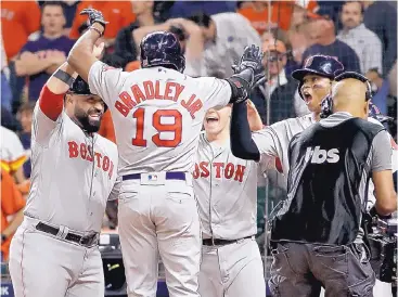  ?? DAVID J. PHILLIP/ASSOCIATED PRESS ?? Boston’s Jackie Bradley Jr. celebrates after he hit a grand slam in the eighthin inning of Game 3 to help the Red Sox beat the Astros Tuesday.