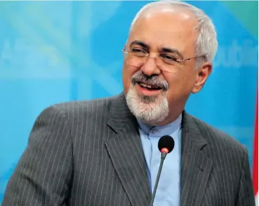  ?? ALI AL-SAADI/Getty Images ?? Iranian officials, including Iranian Foreign Minister Mohammad Javad Zarif, are reassuring the world that they are
committed to limiting uranium enrichment and that the nuclear deal will begin on time