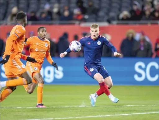  ?? CHICAGO FIRE FC ?? Chris Mueller battles for the ball Saturday night against FC Cincinnati at a frigid Soldier Field. The Fire let a 3-1 lead get away, allowing two late goals.