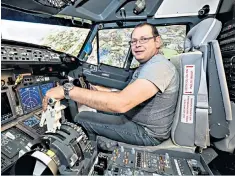  ??  ?? Kenneth Mockford sitting in the Boeing 737-800 flight simulator that he built