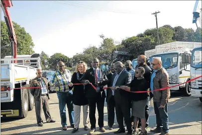  ??  ?? FOR GOOD CAUSE: Buffalo City mayor Xola Pakati is joined by fellow councillor­s as he cuts the ribbon at the parking lot of the King William's Town war memorial, where a fleet of vehicles was officially handed over by suppliers yesterday