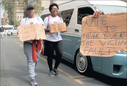  ?? PICTURE: ILANIT CHERNICK ?? STEPPING OUT: Two participan­ts in the annual We, the People Walk. Thousands of people marched through the Joburg CBD holding placards in support of women who have been victims of recent taxi rapes and to commemorat­e 21 years of the constituti­on.
