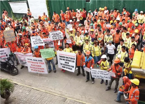  ?? — / ?? APO workers troop to the Naga City Hall to protest their separation from work following the massive landslide in September.PAUL JUN E. ROSAROSO