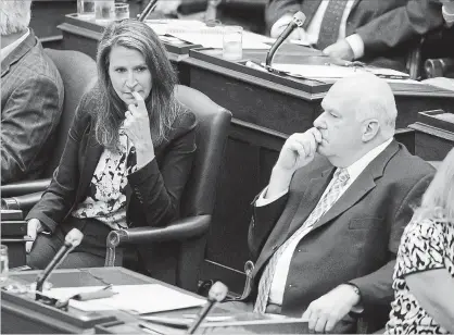  ?? COLE BURSTON THE CANADIAN PRESS ?? Caroline Mulroney, Attorney General of Ontario, left, and Jim Wilson, minister of economic developmen­t, are seen as the legislatur­e sits inside Queens Park in Toronto.