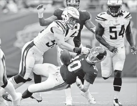  ?? Steven Ryan Getty Images ?? THE CHARGERS’ Joey Bosa sacks Giants quarterbac­k Eli Manning during Sunday’s game. Bosa had two sacks in the first quarter.