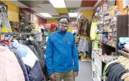  ?? TYLER LARIVIERE/SUN-TIMES PHOTOS ?? William Roland, owner of Looks and Style, stands inside his clothing shop on Friday in the Chatham neighborho­od.