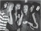  ??  ?? Roger Taylor (Ben Hardy, left), and John Deacon (Joe Mazzello, third from left), join in for “Rhapsody” vocals.