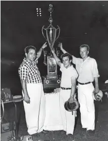  ?? CHICAGO TRIBUNE ?? Anthony“Andy”Granatelli, left, president of the Chicago Auto Racing Associatio­n, with a trophy to be presented to the winner of the Soldier Field stock car title on Sept. 5, 1954. Tom Pistone, center, was the 1953 winner and point standings leader at the time, and Skippy Michaels was the 1952 champ and a 1954 contender.
