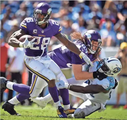  ?? THE TENNESSEAN-USA TODAY SPORTS ?? Vikings running back Adrian Peterson was largely contained by the Tennessee Titans, gaining just 31 yards on Sunday.