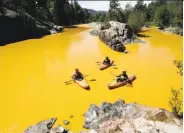  ?? Jerry McBride / Durango (Colo.) Herald ?? Kayakers coast last month on the discolored Animas River near Durango, Colo., after a mine spill.