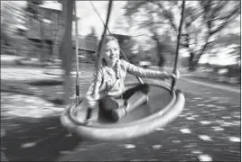  ?? Herald photo by Ian Martens @IMartens Herald ?? Nine-yearold Eliaya Bilec rides a platter swing while visiting the Legion Playground with her family Monday at Henderson Lake.