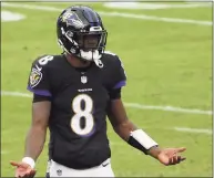  ?? Patrick Smith / TNS ?? Ravens quarterbac­k Lamar Jackson reacts after throwing an intercepti­on against the Titans on Sunday. Jackson is one of more than a dozen Ravens on the COVID-19 list.