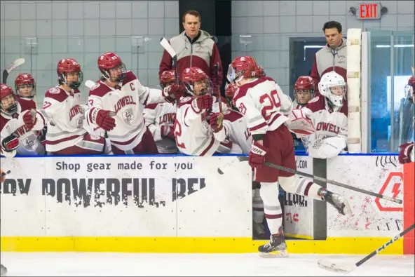  ?? JAMES THOMAS PHOTO ?? Lowell’s Ned Akashian celebrates with teammates after scoring a goal during the opening minutes of the first period. Dracut/tyngsboro, however, posted a 6-1win at the Janas Rink.