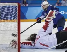  ?? CARLOS GONZALEZ/TNS ?? American Jocelyne Lamoureux-Davidson scores the shootout winner against Canadian goalie Shannon Szabados in the gold-medal game. Top: Silver is little consolatio­n for Brigette Lacquette, left, Lauriane Rougeau, centre, and Rebecca Johnston.