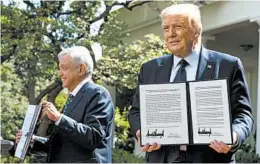  ?? JIM WATSON/GETTY-AFP ?? President Trump and Mexican leader Andres Manuel Lopez Obrador hold up a joint declaratio­n during a news conference Wednesday in the Rose Garden at the White House.