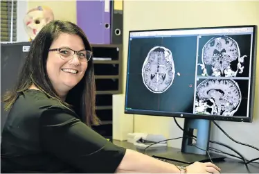  ?? Pictures: EUGENE COETZEE ?? REMOTE SURGERY: Oncologist Dr Cathryn Walton uses groundbrea­king new remote technology and gamma knife radiation equipment to treat patients with brain tumours