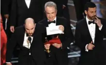  ?? CHRIS PIZZELLO, THE ASSOCIATED PRESS ?? “La La Land” producer Jordan Horowitz shows the envelope revealing “Moonlight” as the true winner of best picture at the Oscars. “Guys, guys ... I’m sorry, NO! There’s a mistake,” he announced.