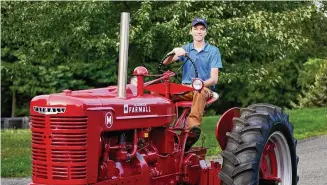  ?? ChiChi Ubina/Contribute­d photo ?? Andrew Hanna, of Greenwich, is the grand champion of the Chevron Tractor Restoratio­n Competitio­n. He won for restoring a 1942 Farmall M.