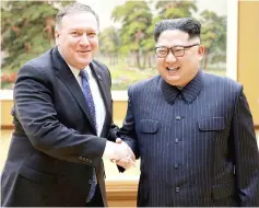  ??  ?? Kim shakes hands with Pompeo in this file picture. — Reuters photo