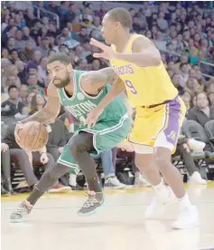  ??  ?? Boston Celtics guard Kyrie Irving (left) moves the ball against Los Angeles Lakers guard Rajon Rondo during the second half at Staples Center. — USA TODAY Sports photo