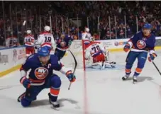  ?? BRUCE BENNETT/GETTY IMAGES ?? Islanders captain John Tavares celebrates his game-winning OT goal against Capitals goalie Braden Holtby on Sunday in Uniondale, N.Y.