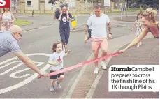  ??  ?? Hurrah Campbell prepares to cross the finish line of his 1K through Plains