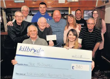  ??  ?? Tache cash Joe McDowell and his Legion Scotland pals present cheque to hospice’s Karlyn Robertson