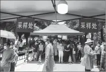  ?? CHEN FAN / FOR CHINA DAILY ?? People wait for COVID-19 nucleic acid testing in Xiegang town, Dongguan, Guangdong province, on Monday, after a citywide testing campaign was launched.