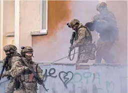  ?? DIMITAR DILKOFF/AFP VIA GETTY IMAGES ?? Ukrainian servicemen take part in a joint military training Saturday in the Rivne region, near the border with Belarus. The owner of the Russian Wagner Group private military contractor said in a video released Friday that the war could drag on for years.