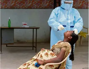  ?? AFP ?? A pregnant woman gets tested for SARS-CoV-2 infection in Hyderabad, India. Three in four pregnant women with Covid-19 display no symptoms. —