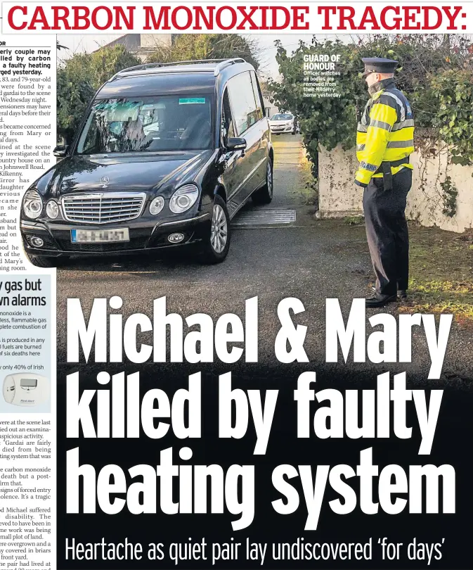  ??  ?? GUARD OF HONOUR Officer watches as bodies are removed from their Kilderry home yesterday