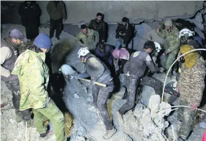  ?? Omar Haj Kadour / AFP ?? Syrian volunteers search for survivors in the rubble of a village mosque that was hit by an air strike in Aleppo on Thursday.