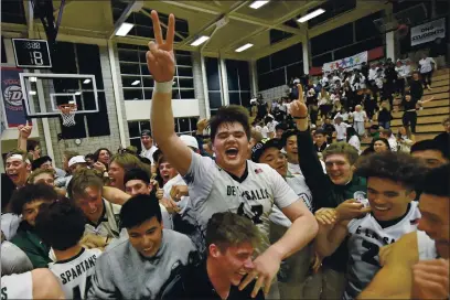  ?? JOSE CARLOS FAJARDO — BAY AREA NEWS GROUP, FILE ?? De La Salle’s Noah Clifford (42) celebrates with his teammates and fans after defeating Granada High during their 2020 North Coast Section Division I boys basketball final at Dublin High School in Dublin.