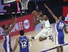  ?? Ap pHOtOs ?? COMING DOWN THE LANE: Semi Ojeleye gets by Philadelph­ia’s Shake Milton during the second quarter of the Celtics’ 110-106 win on Sunday.